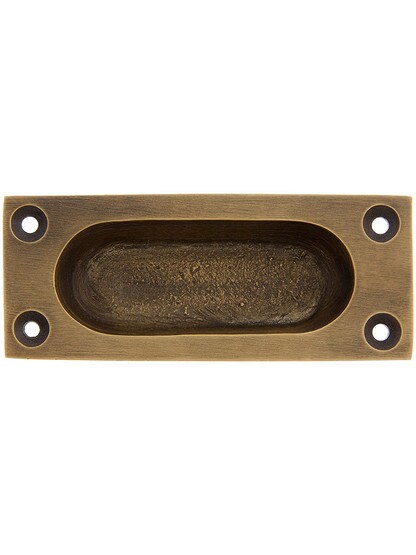 Cast Brass Flush Mount Sash Lift With Oval Inset In Antique Brass.